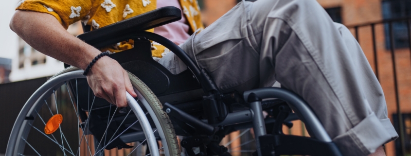 Close up of young Gen Z boy in a wheelchair in the city. Inclusion, equality, and diversity among Generation Z people.