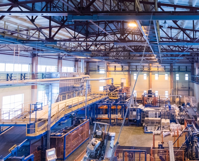 Factory workshop interior and machines on glass production background